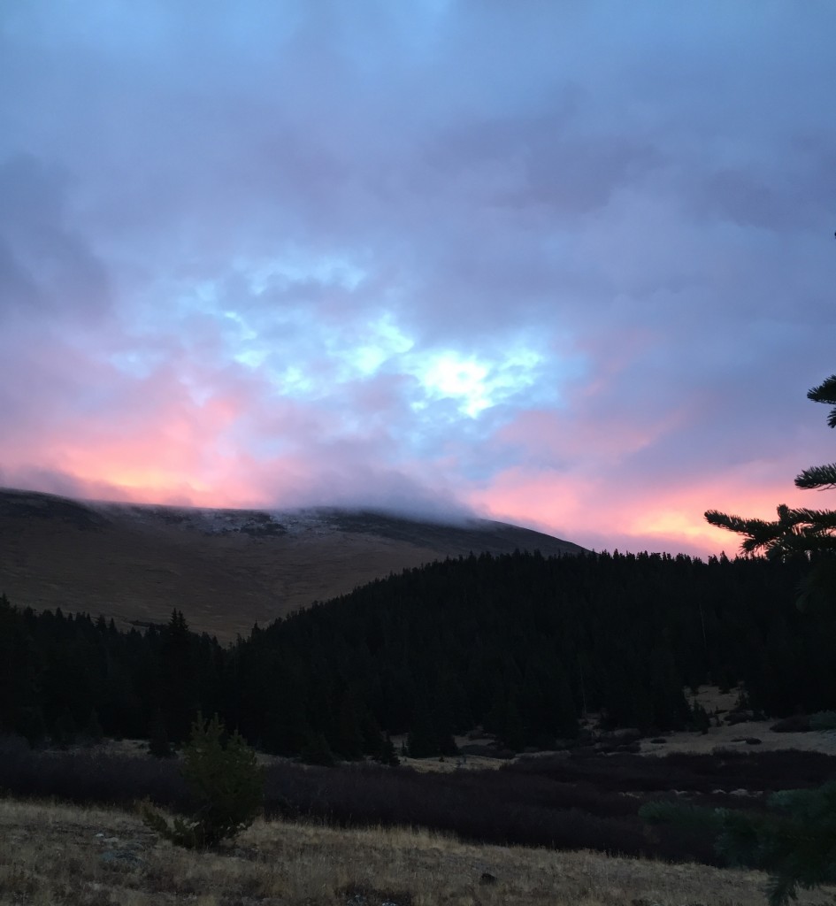 Dawn breaks over the snow-tipped clearing above tree line on Weston Pass.